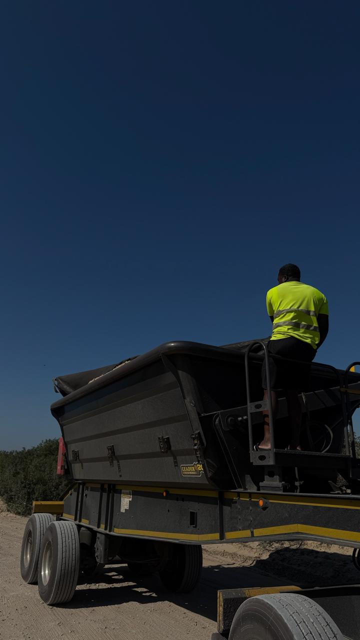 CWG team member on truck at dusk, safety vest visible